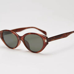 Tortoiseshell cat-eye sunglasses with dark lenses, slim arms