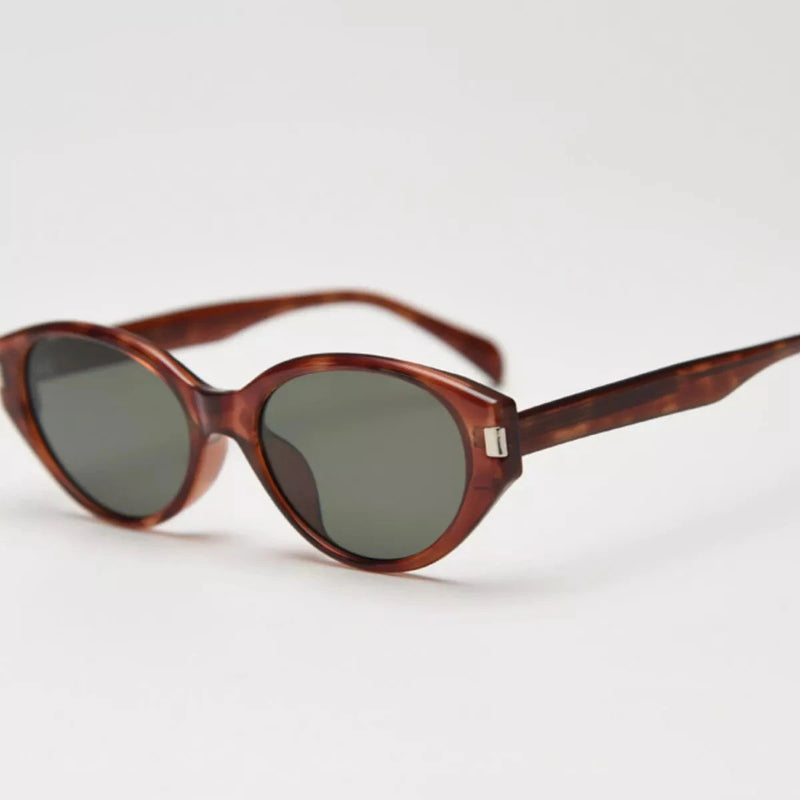 Tortoiseshell cat-eye sunglasses with dark lenses, slim arms