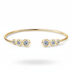 Gold-tone bracelet with five round clear stones and open cuff design
