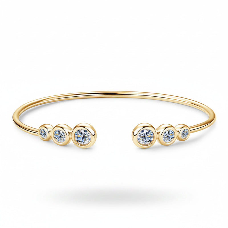 Gold-tone bracelet with five round clear stones and open cuff design