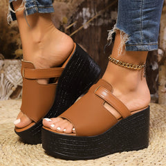 Open-toe wedge sandal with tan cross straps and black textured platform base