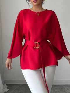 Red batwing blouse with long loose sleeves and belt with square buckle