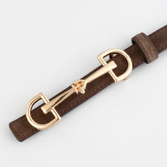 Close-up of brown leather belt with gold-tone double ring buckle hardware on strap.