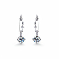 Silver drop hoop earrings with round moissanite centerpiece and small side stones