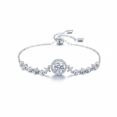 Silver moissanite bracelet with round bezel centerpiece and alternating pavé motifs