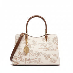 Ivory embroidered leather handbag with brown shoulder strap and gold hardware, front view
