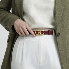 Red leather-look belt with gold-tone oval buckle and center bar, worn at waist