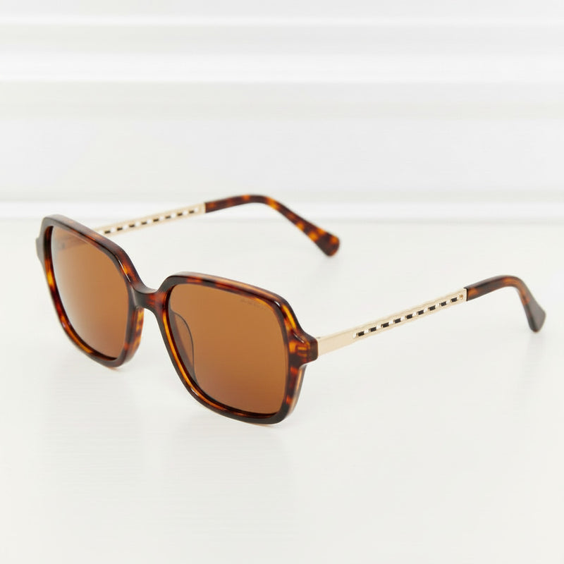 Brown tortoiseshell full-rim sunglasses with amber-tinted lenses and metal temples