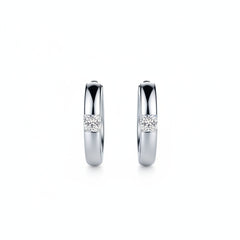 925 sterling silver huggie earrings with embedded round moissanite stones, front view