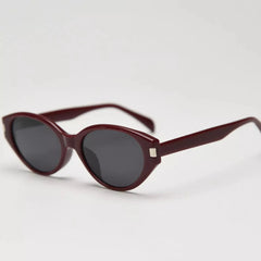 Tortoiseshell cat-eye sunglasses with dark lenses and front badge