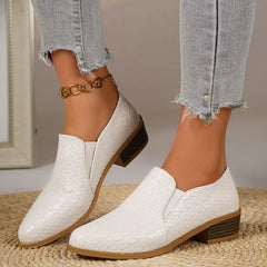 Point-toe block heel loafers in white, textured upper with gold chain ankle detail.