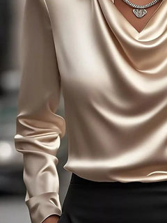 Tan satin long-sleeve blouse with smooth drape and pointed collar at neckline