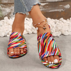 Open toe flat sandals with colorful striped fabric straps and low rubber sole