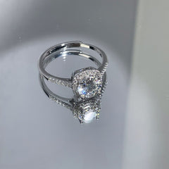 Silver halo solitaire ring with prong-set round gemstone, top view