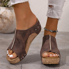 Brown open-toe wedge sandals with stud trim, cork-look sole, and beaded ankle bracelet