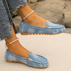 Light blue denim round-toe flat loafers with buckle detail and pearl ankle chain strap