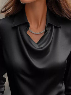 Black satin cowl-neck blouse with V drape and pointed collar, close-up