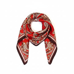 Deep red silk paisley scarf draped with white and tan ornamental swirls and dark edge