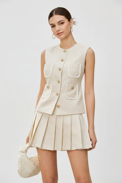 Beige tweed sleeveless button-front vest with patch pockets and pleated mini skirt