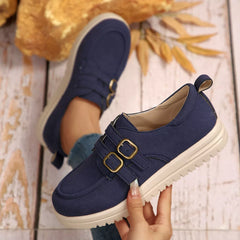 Navy suede buckle-accent casual loafers with double buckle strap detail and white sole