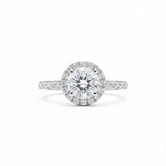 Round moissanite solitaire ring with halo surround and pavé-set band in silver