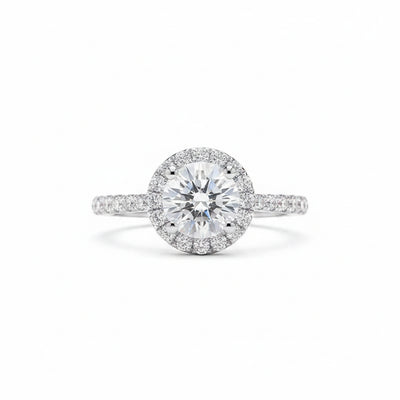 Round moissanite solitaire ring with halo surround and pavé-set band in silver