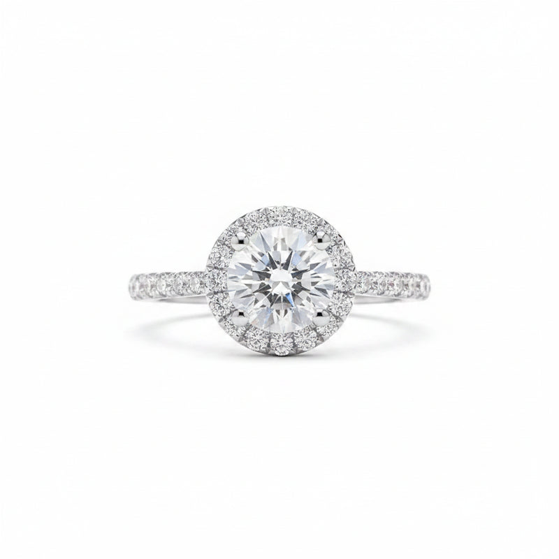 Round moissanite solitaire ring with halo surround and pavé-set band in silver