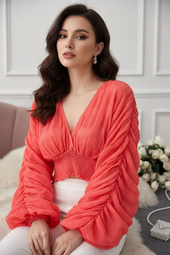 Orange smocked ruched long-sleeve blouse with V-neck and gathered bodice