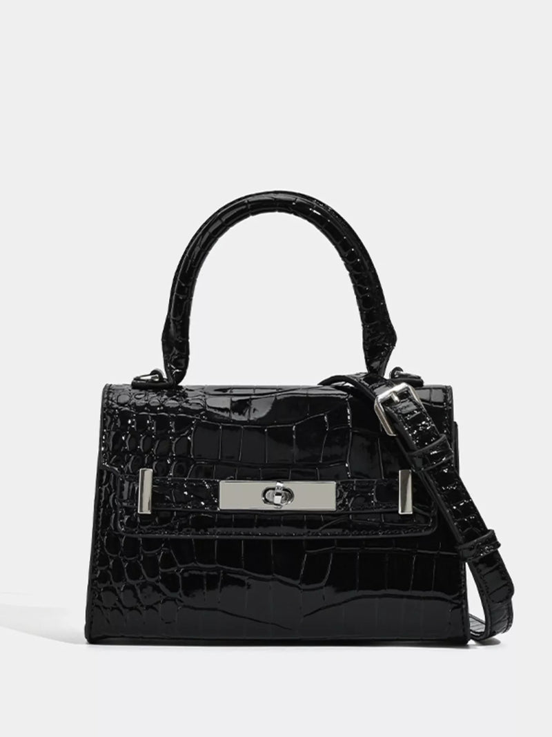 Black croc-embossed top-handle handbag with front plaque and shoulder strap