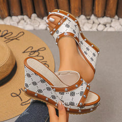 Peep toe wedge sandals with patterned straps and studded edges, front side view