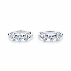 Sterling silver huggie hoop earrings with three round moissanite stones, front view
