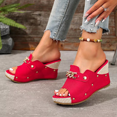 Rose red open-toe wedge sandals with chain buckle strap and stud accents.