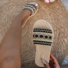 Open toe flat sandals with black-and-gold embroidered side detail and rope sole