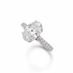 Oval moissanite solitaire ring in sterling silver with pavé side accents