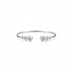 Silver-tone bracelet with three-stone segment and two end stones on open cuff