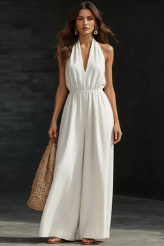 White halter-neck wide-leg jumpsuit with deep V neckline and gathered waist