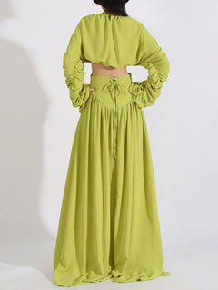 Green back view of ruched long-sleeve crop top and high-waist maxi skirt set