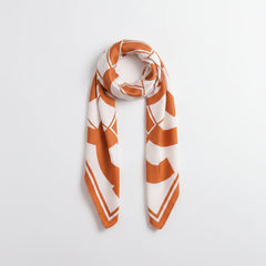 Square flower silk scarf tied into a loop, sherbet orange and white pattern