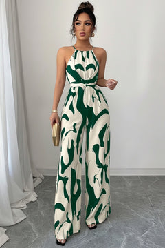 Sleeveless wide-leg jumpsuit with abstract green-and-white print and tied waist detail