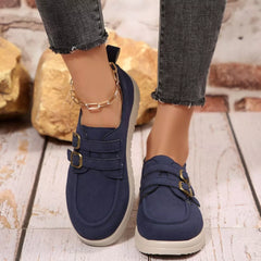 Navy casual loafers with buckle strap accents and white rubber sole