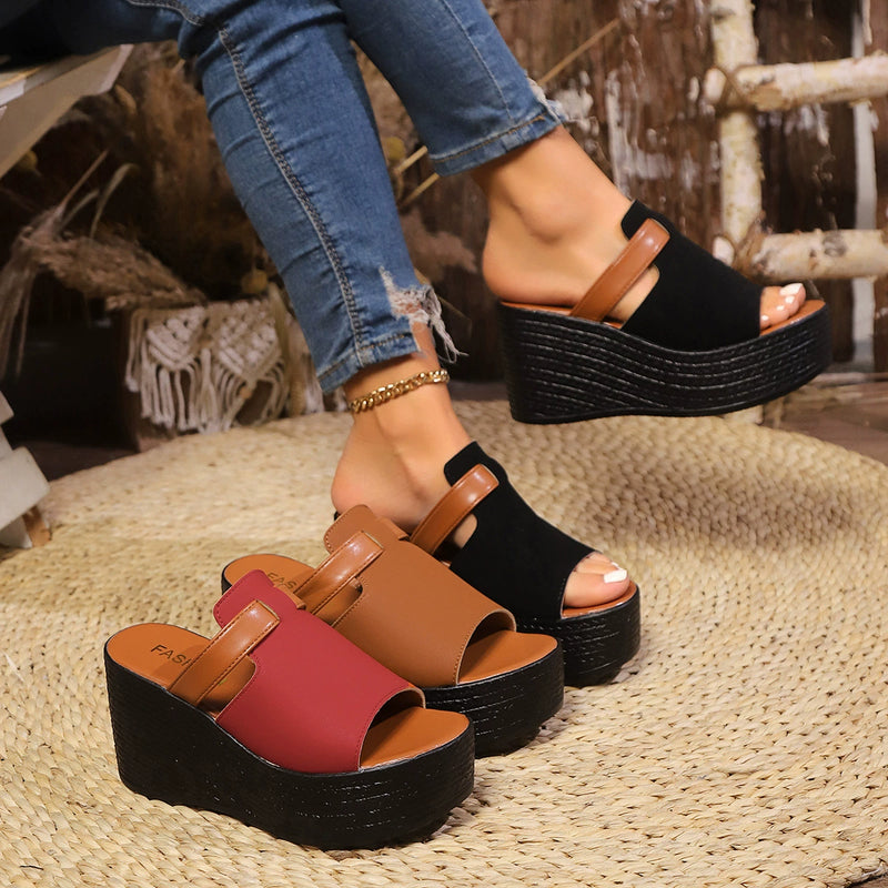 Open-toe wedge sandals with tan and red straps and black platform base