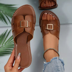 Coffee-brown open-toe flat sandals with cutout center and square gold-tone buckle.