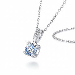 Sterling silver moissanite pendant with prong-set cushion-cut stone and pavé frame, side view