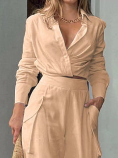 Tan wrap-style long-sleeve shirt with V-neck and belted waist