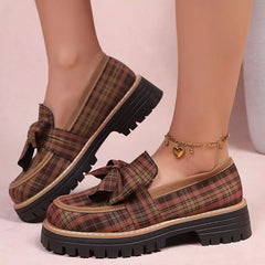 Plaid chunky loafers with front bow, tan plaid upper and dark rugged sole