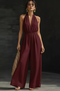 Burgundy halter-neck wide-leg jumpsuit with V-neck and pleated waist