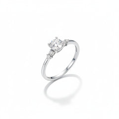 Sterling silver solitaire ring with round moissanite center and surrounding pavé stones