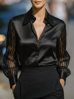 Black collared button-up shirt with sheer striped sleeves and satin finish
