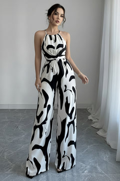 Sleeveless wide-leg jumpsuit with abstract black-and-white print and tied waist detail