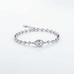 Sterling silver moissanite bracelet with round blue center stone and small clear stones
